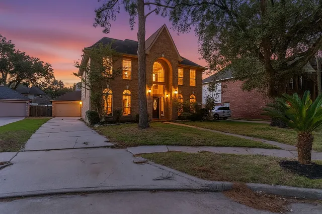 a front view of a house with a yard and a garage