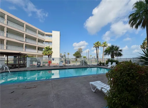 a patio with a table and chairs