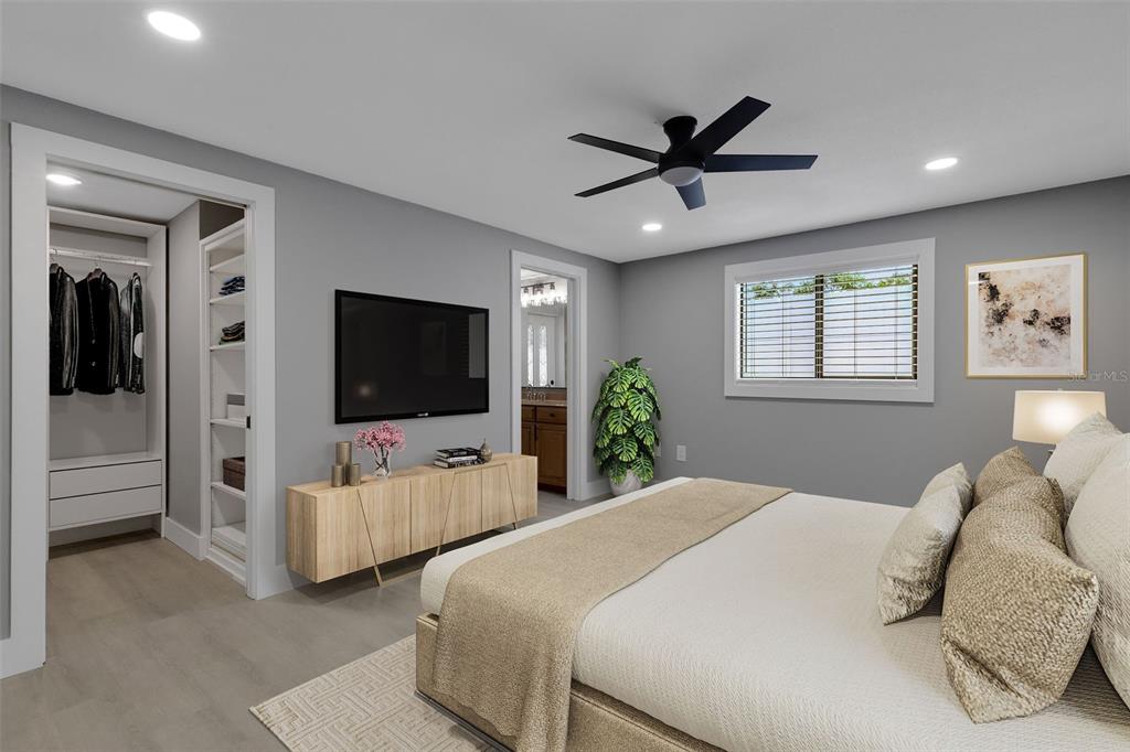 4645 Hunter Ridge Drive Sarasota, FL 34233 - Photo 11 of 70 a bedroom with bed tv and window