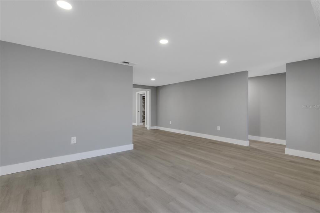 4645 Hunter Ridge Drive Sarasota, FL 34233 - Photo 17 of 70 a view of an empty room with wooden floor