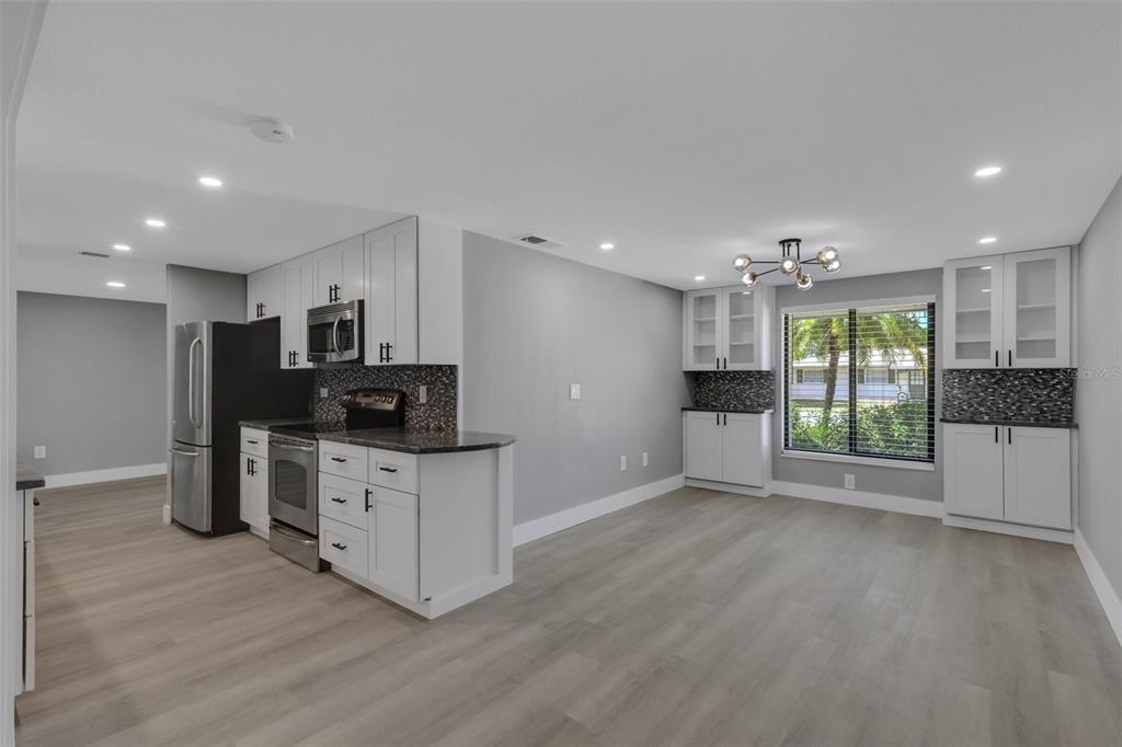 4645 Hunter Ridge Drive Sarasota, FL 34233 - Photo 28 of 70 a kitchen with stainless steel appliances kitchen island granite countertop a stove and a refrigerator