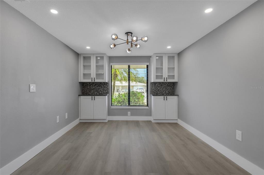 4645 Hunter Ridge Drive Sarasota, FL 34233 - Photo 29 of 70 wooden floor in an empty room with a window