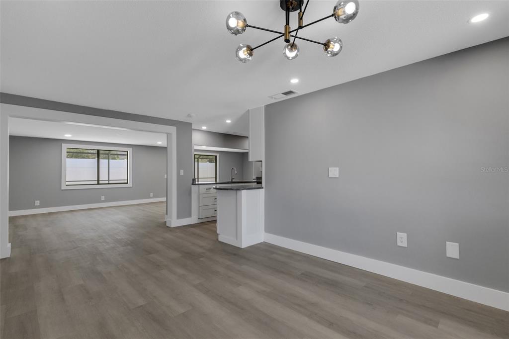 4645 Hunter Ridge Drive Sarasota, FL 34233 - Photo 31 of 70 an empty room with wooden floor ceiling fan and windows