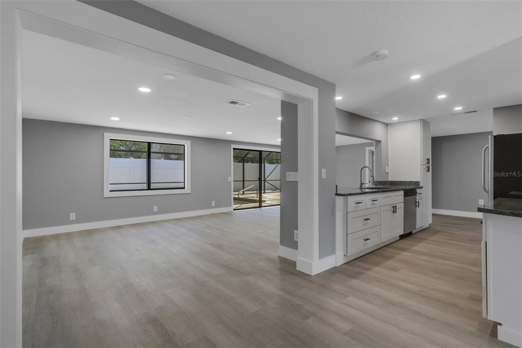4645 Hunter Ridge Drive Sarasota, FL 34233 - Photo 32 of 70 a large kitchen with stainless steel appliances a large counter top a stove and a refrigerator