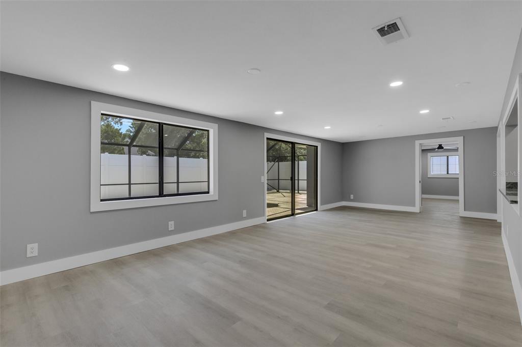 4645 Hunter Ridge Drive Sarasota, FL 34233 - Photo 33 of 70 a view of an empty room with a window and wooden floor