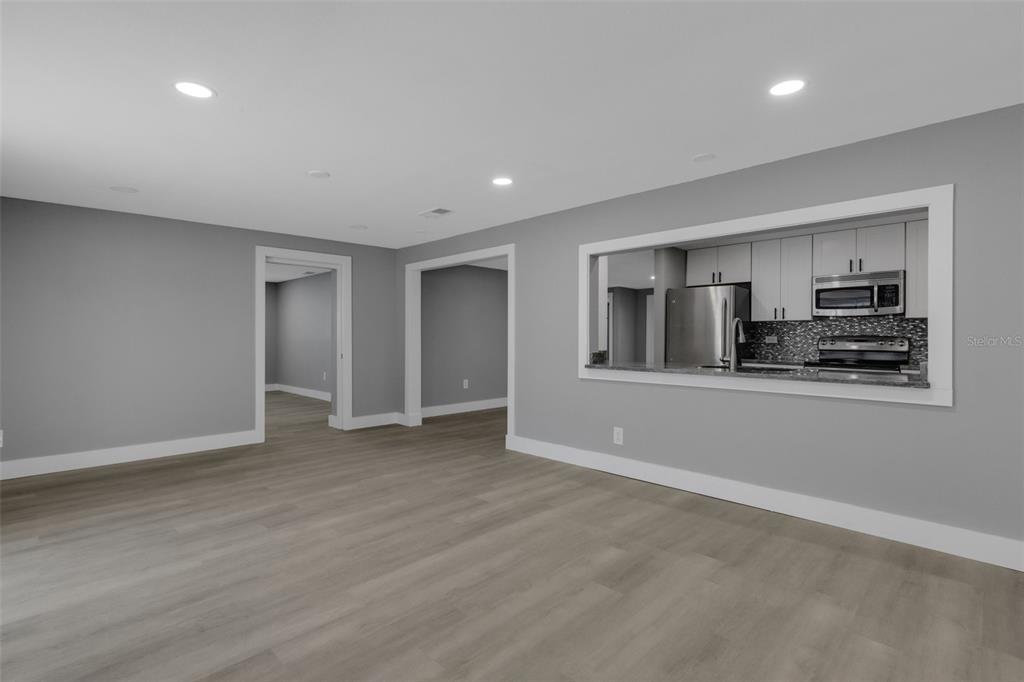 4645 Hunter Ridge Drive Sarasota, FL 34233 - Photo 36 of 70 a view of empty room with kitchen and window