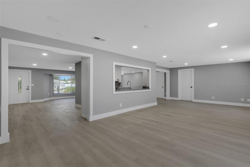4645 Hunter Ridge Drive Sarasota, FL 34233 - Photo 39 of 70 a view of an empty room with wooden floor and a window