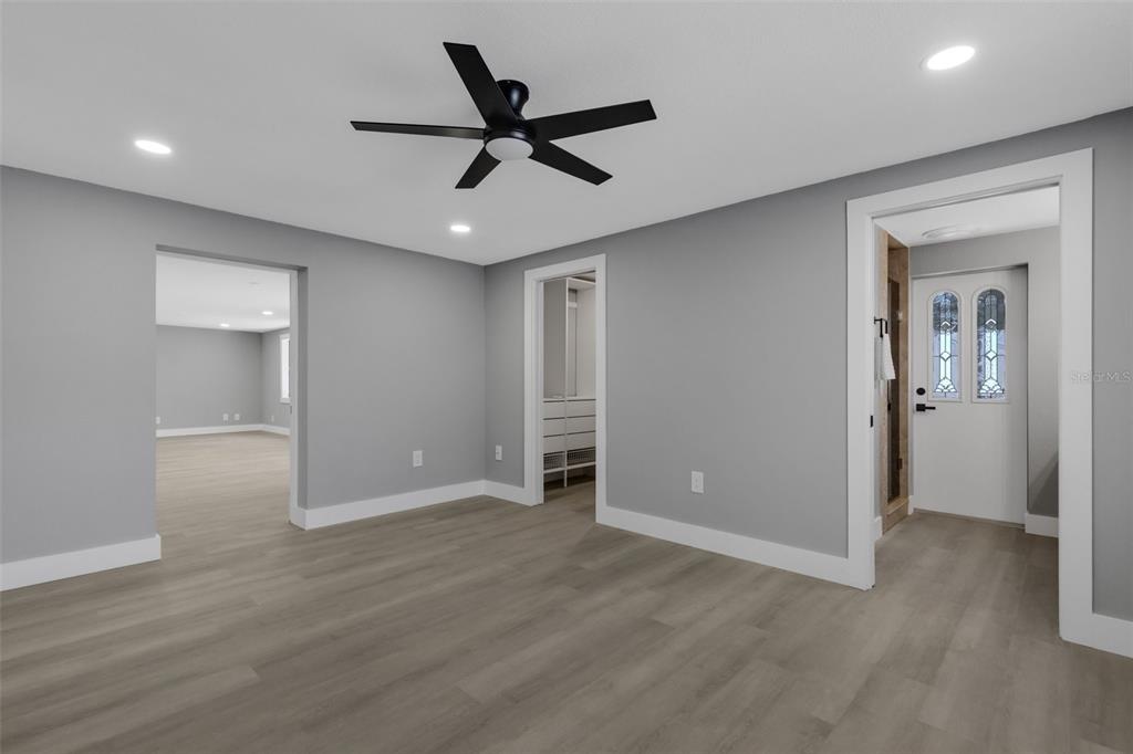 4645 Hunter Ridge Drive Sarasota, FL 34233 - Photo 43 of 70 a view of a livingroom with a ceiling fan & entryway