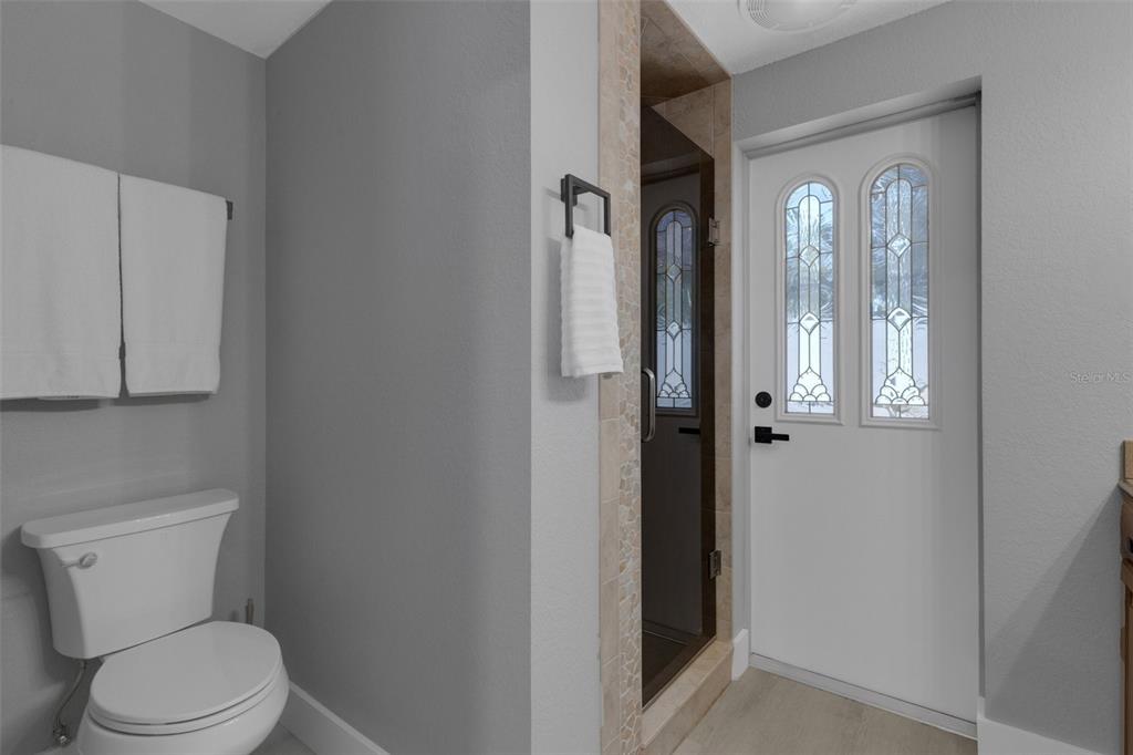 4645 Hunter Ridge Drive Sarasota, FL 34233 - Photo 45 of 70 a white toilet sitting next to a bathroom sink