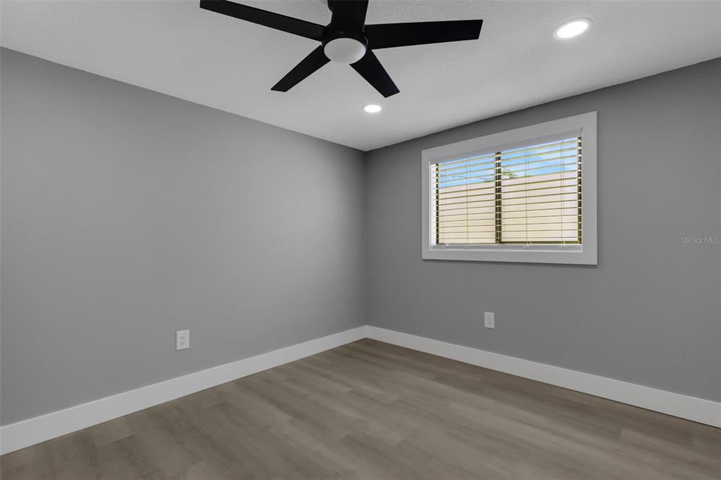 4645 Hunter Ridge Drive Sarasota, FL 34233 - Photo 50 of 70 an empty room with a window and a fan