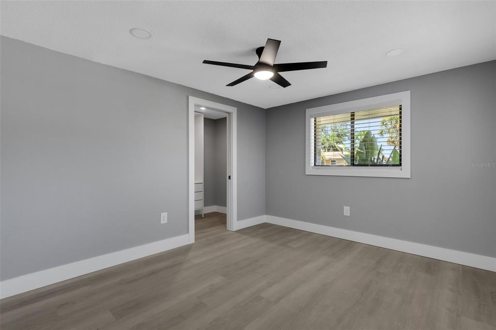 4645 Hunter Ridge Drive Sarasota, FL 34233 - Photo 51 of 70 a view of an empty room with wooden floor and a window