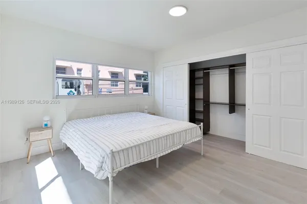 a bedroom with a bed and a window