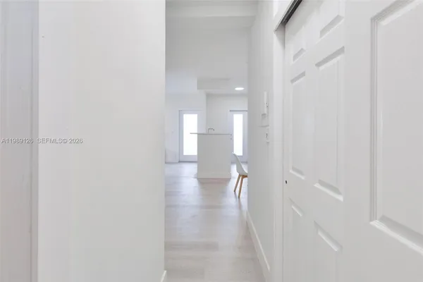 a view of a hallway with a white walls
