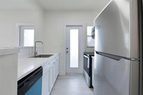 a kitchen with a sink and refrigerator