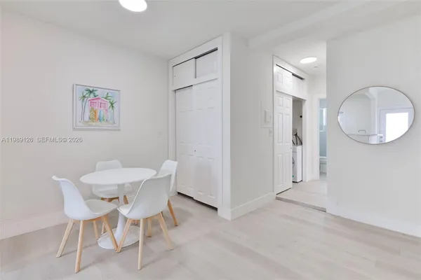 a view of a livingroom with furniture and a mirror