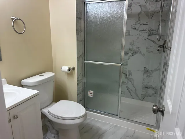 a bathroom with a shower and toilet