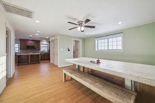 a spacious bedroom with a bed and a flat screen tv