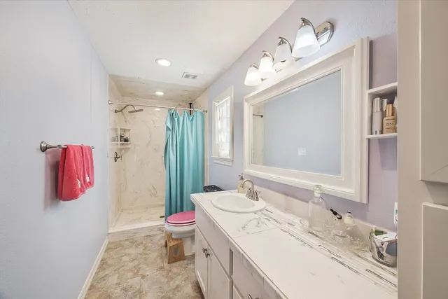 a bedroom with a bed and a ceiling fan