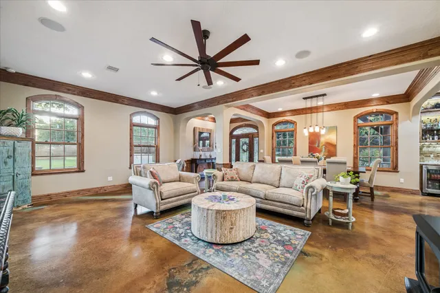 a living room with furniture ceiling fan and a rug