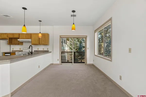 a large white room with kitchen area