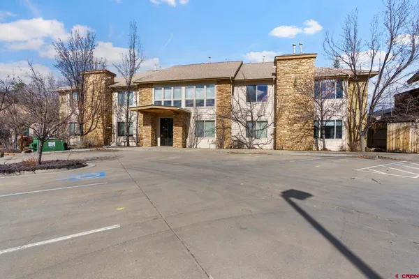 an empty room with windows and fireplace