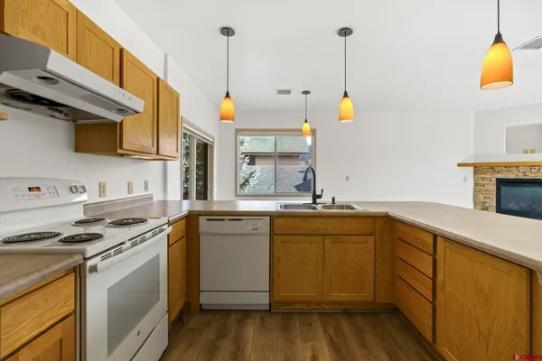 a kitchen with stainless steel appliances a sink a stove and a refrigerator