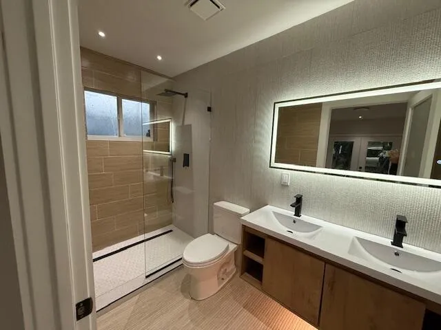 a bathroom with a sink toilet and shower