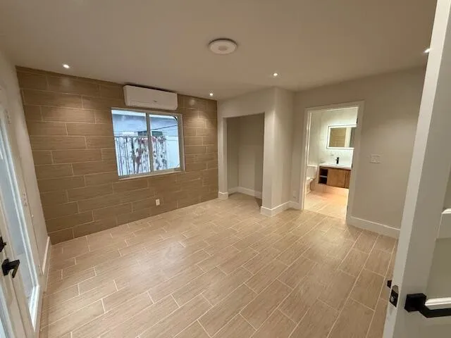 a view of a big room with windows and cabinet