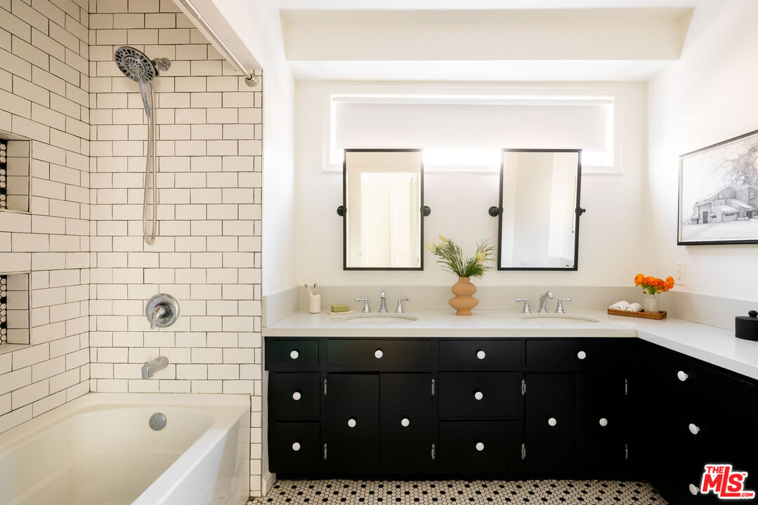 1410 Norton Avenue Glendale, CA 91202 - Photo 13 of 20 a bathroom with a double vanity sink a mirror a bathtub and shower