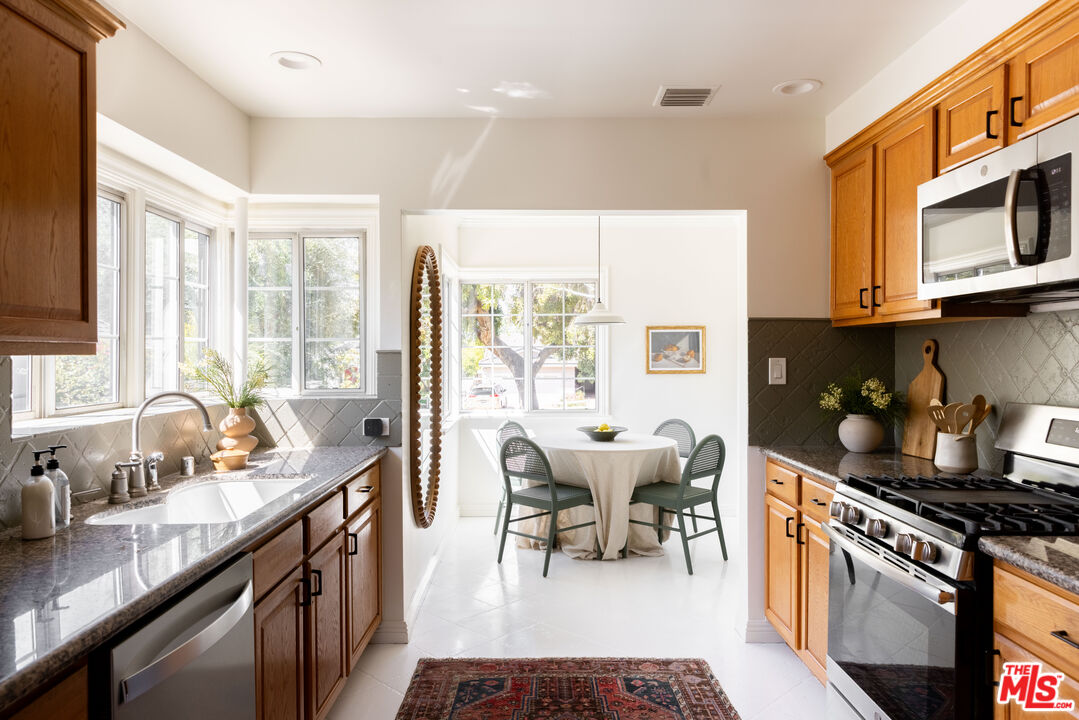 1410 Norton Avenue Glendale, CA 91202 - Photo 7 of 20 a kitchen with stainless steel appliances granite countertop a stove a sink and a microwave