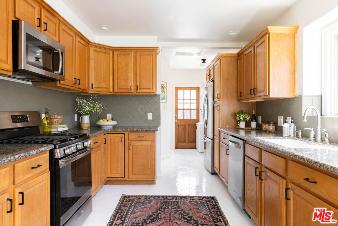 1410 Norton Avenue Glendale, CA 91202 - Photo 8 of 20 a kitchen with stainless steel appliances granite countertop a stove a sink dishwasher and a refrigerator