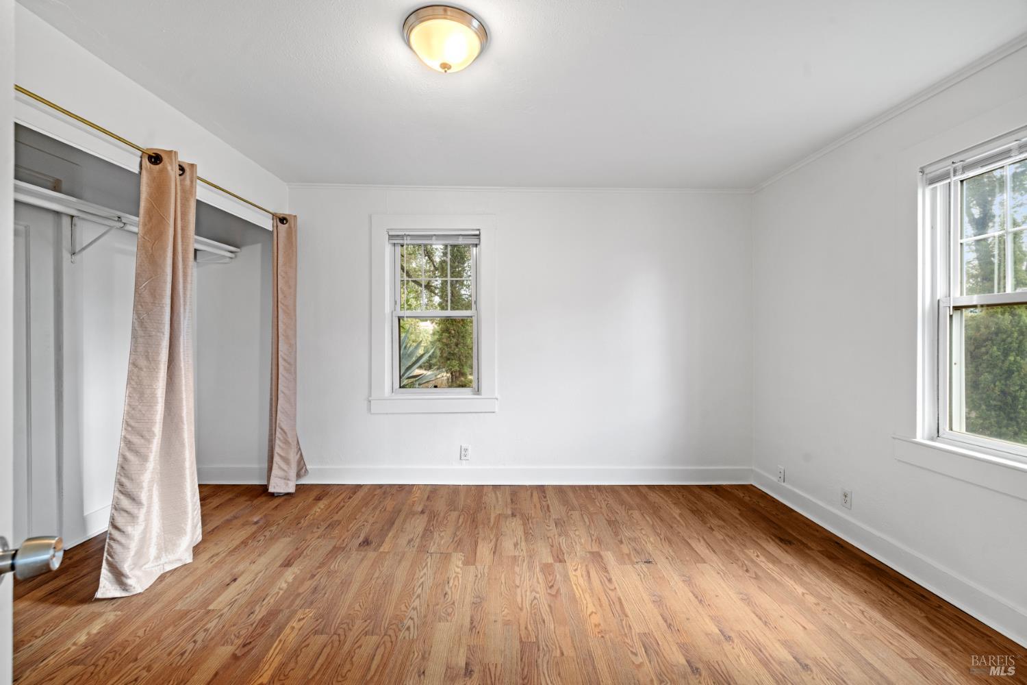 3160 Sunridge Drive Santa Rosa, CA 95404 - Photo 11 of 45 an empty room with wooden floor and windows