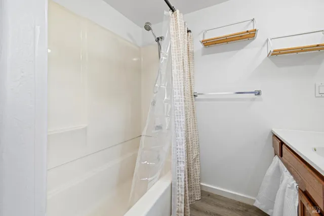 a bathroom with a shower and a glass door