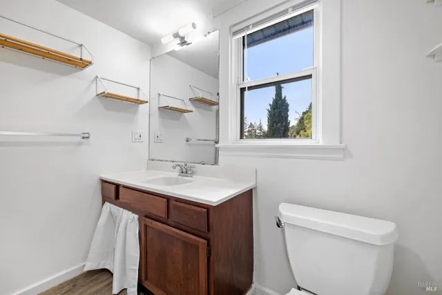 a bathroom with a toilet a sink and a mirror