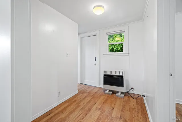 a view of a room with wooden floor and fireplace