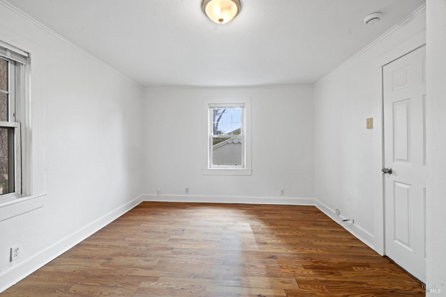 3160 Sunridge Drive Santa Rosa, CA 95404 - Photo 16 of 45 a view of an empty room with wooden floor and window