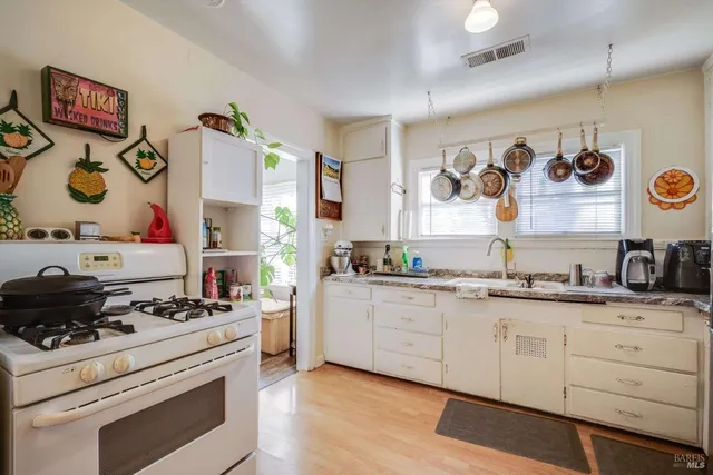 a kitchen with a stove and cabinets