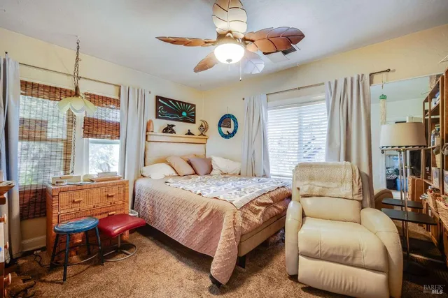 a bedroom with a bed a couch and a window