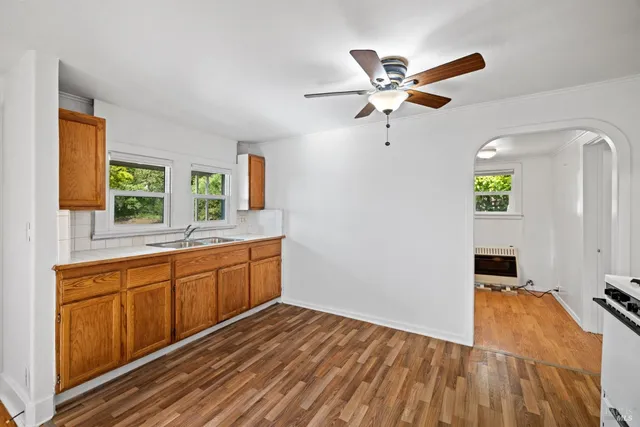 a kitchen with a refrigerator a sink and a window