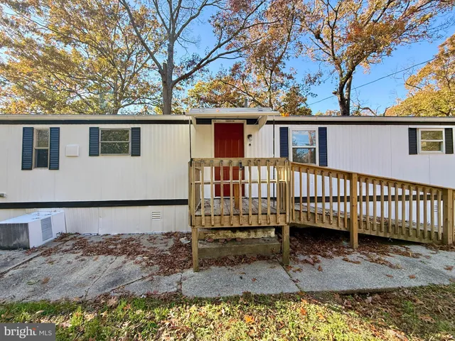 a view of a house with a wooden deck