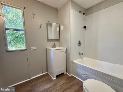 a bathroom with a toilet a sink and a bathtub
