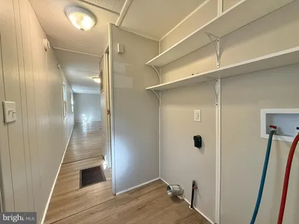 a view of hallway with wooden floor