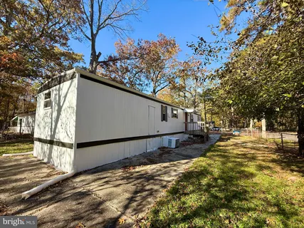 a view of a yard with wooden fence