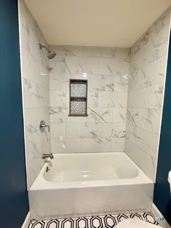 a bathroom with a bathtub and a shower