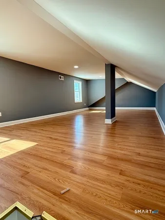 a view of empty room with wooden floor
