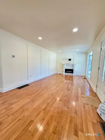 a view of an empty room with wooden floor