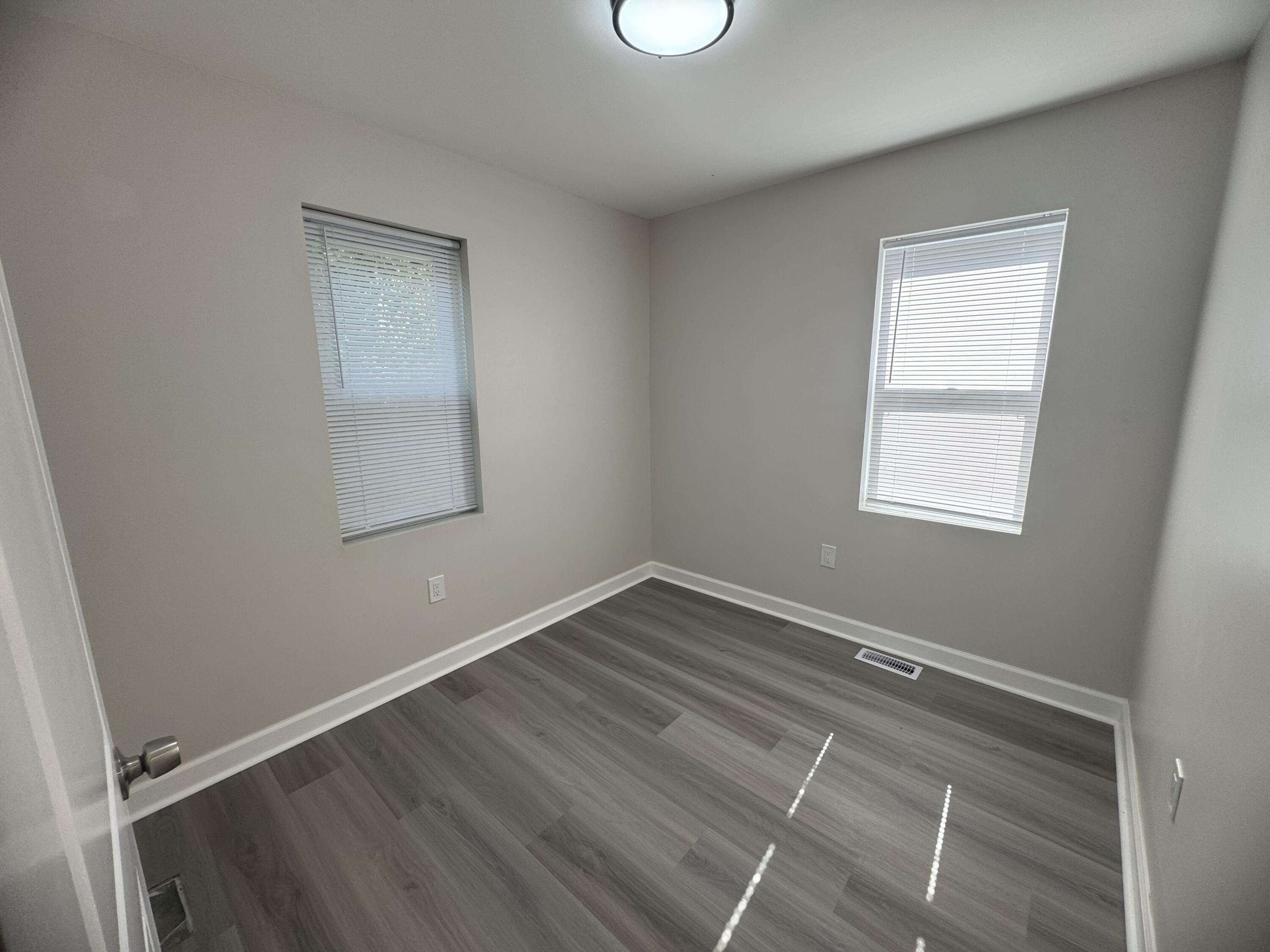 2344 Virginia Street Gary, IN 46407 - Photo 5 of 13 an empty room with wooden floor and windows