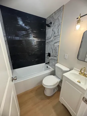 a bathroom with a sink toilet and shower