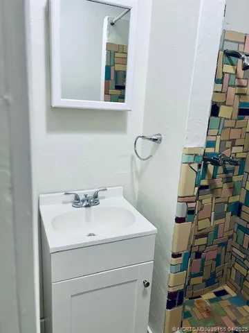 a bathroom with a toilet sink and mirror