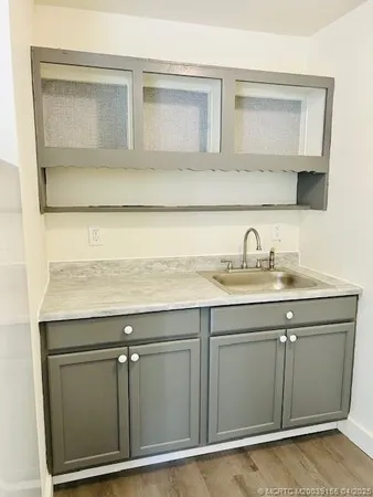 a view of kitchen and utility room with wooden floor